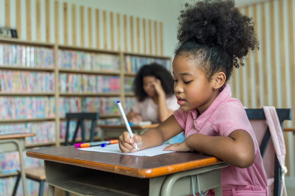 A student at their desk coloring